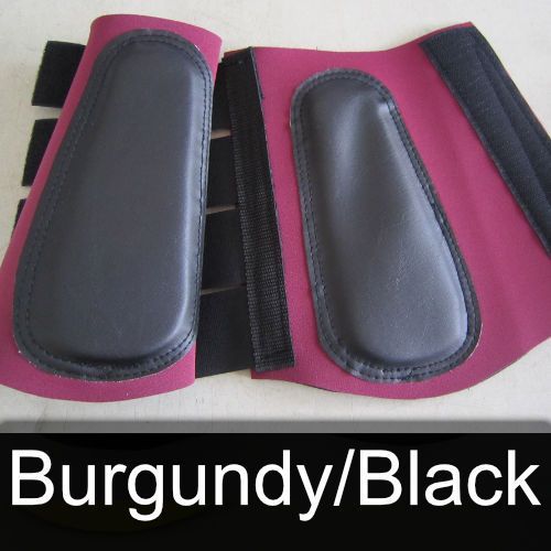 A pair of burgundy and black boots on a table