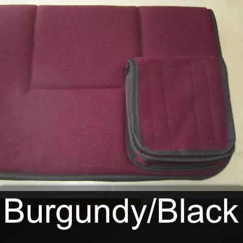 A burgundy and black blanket is sitting on a table