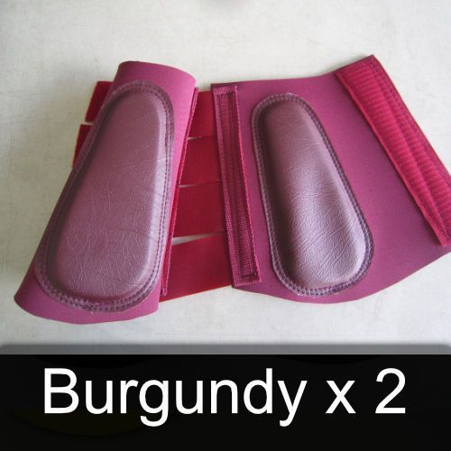A pair of burgundy x 2 boots on a white surface