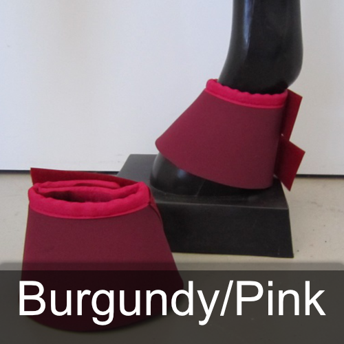 A pair of burgundy and pink bell boots on a horse