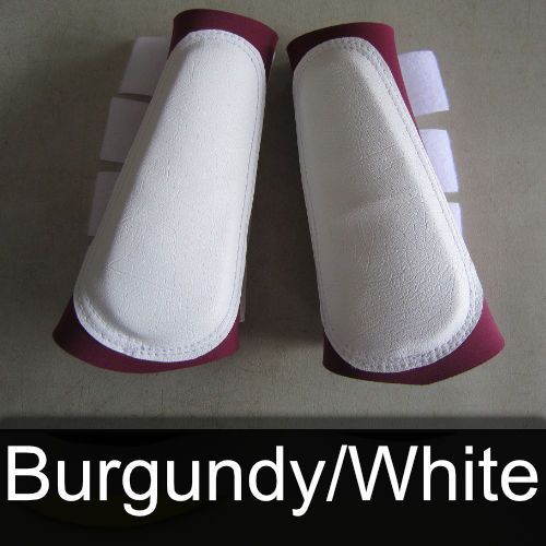 A pair of burgundy and white boots on a table