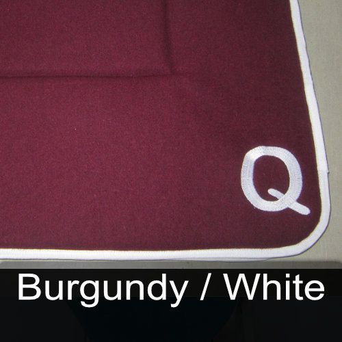 A burgundy and white rug with the letter q on it