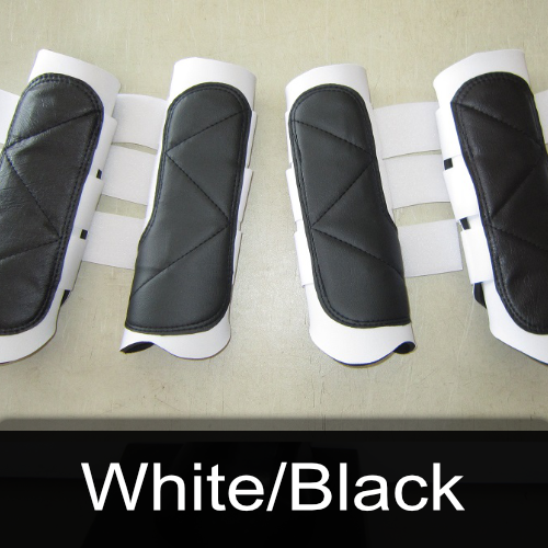 A row of black and white boots with the words white / black below them