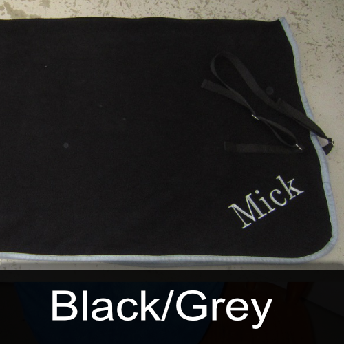 A black towel with the name mick embroidered on it
