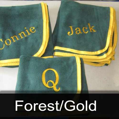 Three green blankets with the names connie and jack embroidered on them