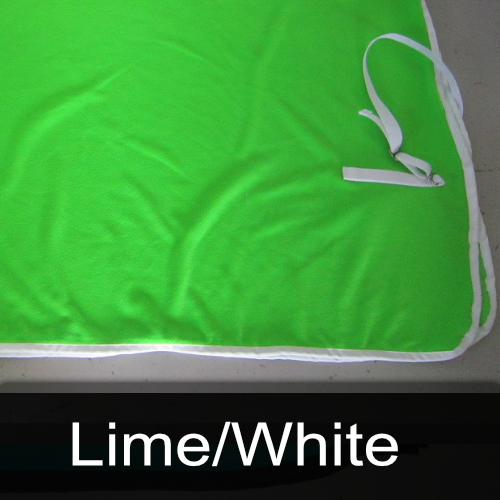 A green blanket with white trim is labeled lime / white