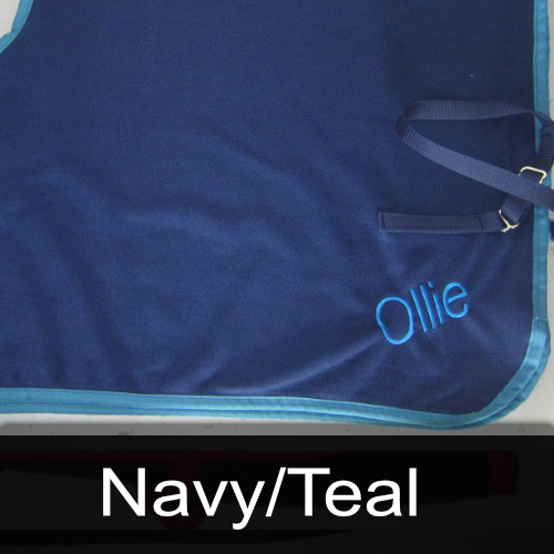A blue blanket with the name ollie embroidered on it