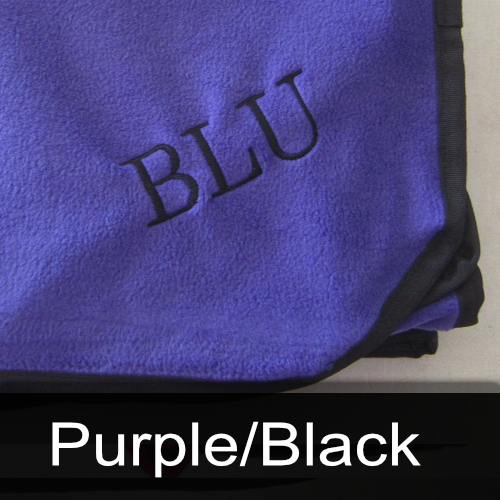 A purple blanket with the name blu embroidered on it