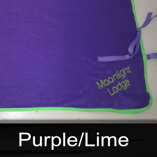 A purple blanket with the words moonlight lodge embroidered on it