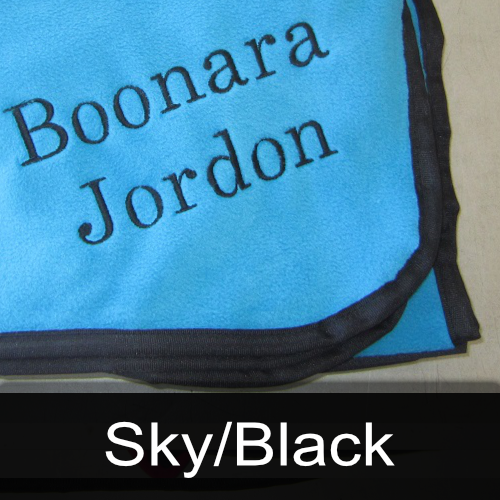 A blue blanket with the name jordon embroidered on it