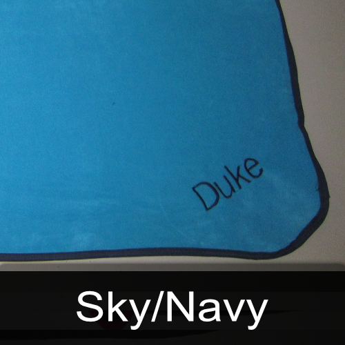 A blue blanket with the name duke embroidered on it