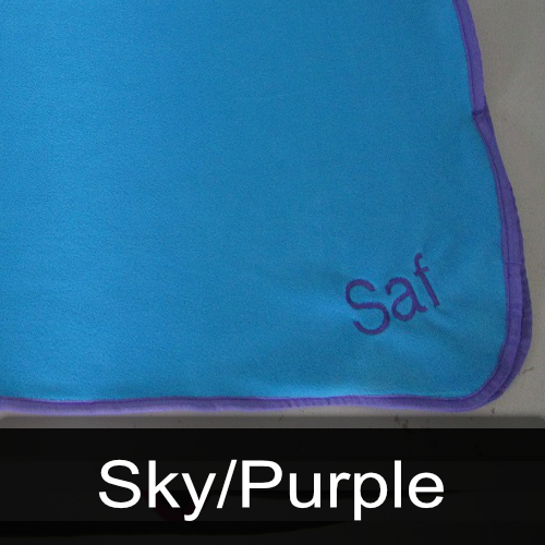 A blue blanket with the name saf embroidered on it