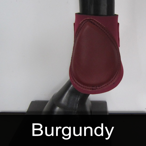 A picture of a burgundy boot on a horse 's leg