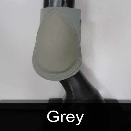 A close up of a horse 's leg with a grey boot on it.