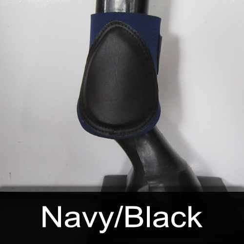 A close up of a horse 's leg with a black boot on it.