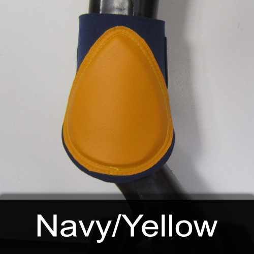 A pair of navy and yellow boots on a horse 's leg.