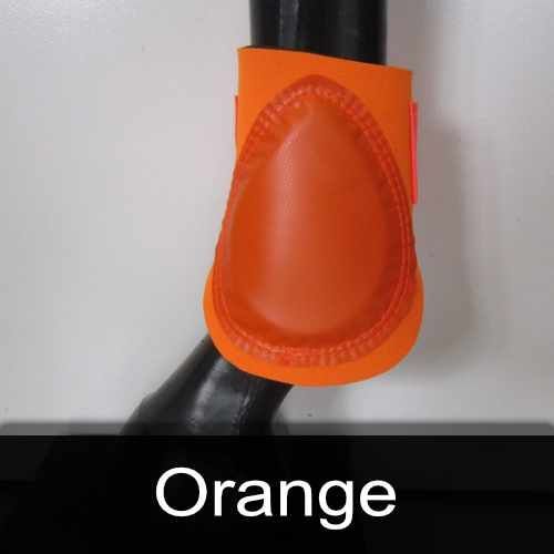 A close up of an orange boot on a horse 's leg.