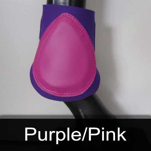 A pair of purple and pink boots on a horse 's leg