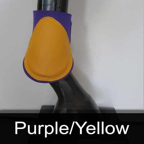 A purple and yellow boot is on a horse 's leg.