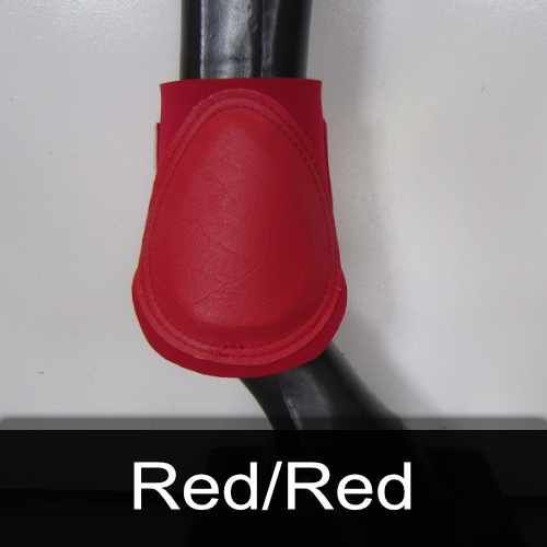 A close up of a red boot on a horse 's leg.