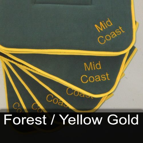 A stack of coasters with the words mid coast embroidered on them