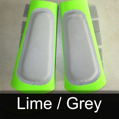 A pair of lime and grey leg protectors on a table