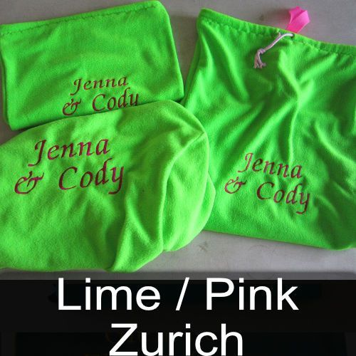 A lime / pink zurich blanket with jenna and cody embroidered on it