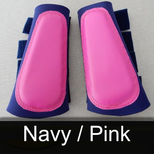 A pair of navy and pink boots are sitting on a table.