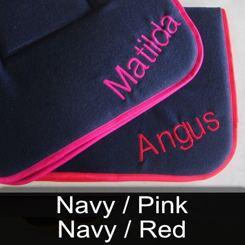 Two blankets with the names matilda and angus embroidered on them
