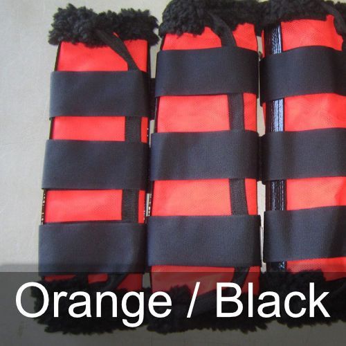 A pair of orange and black leg wraps on a table