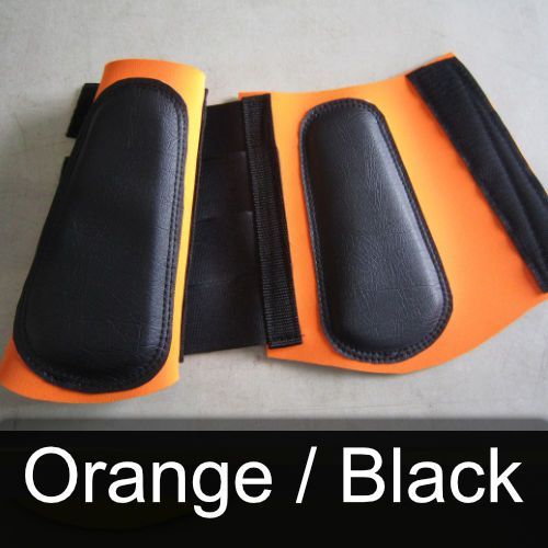 A pair of orange and black boots on a table