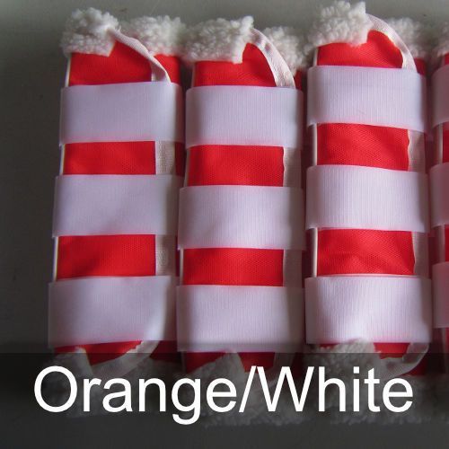 A row of red and white striped boots with the words orange / white below them