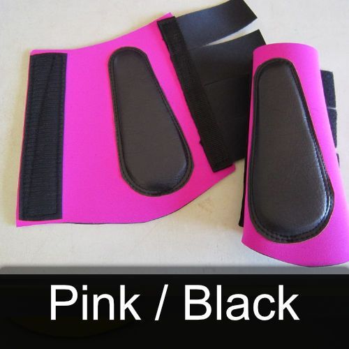 A pair of pink and black boots are on a table