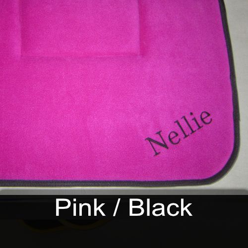 A pink towel with the name nellie embroidered on it