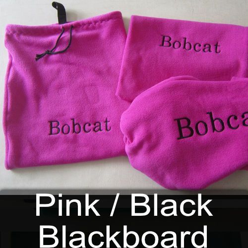 A pink and black blackboard with bobcat embroidered on it