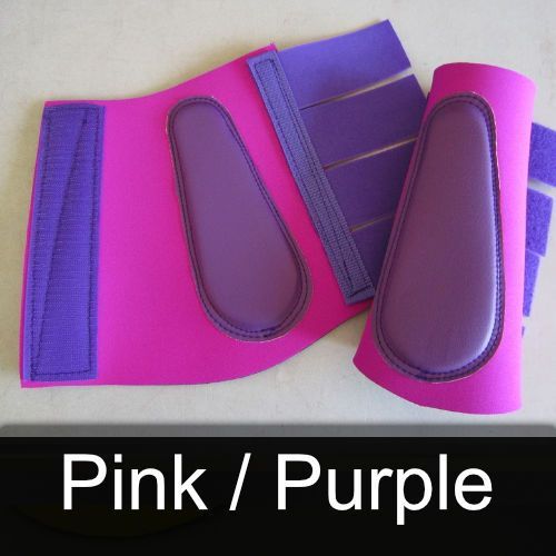 A pair of pink and purple boots sit on a table