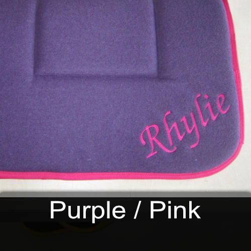 A purple cushion with the name rhylie embroidered on it