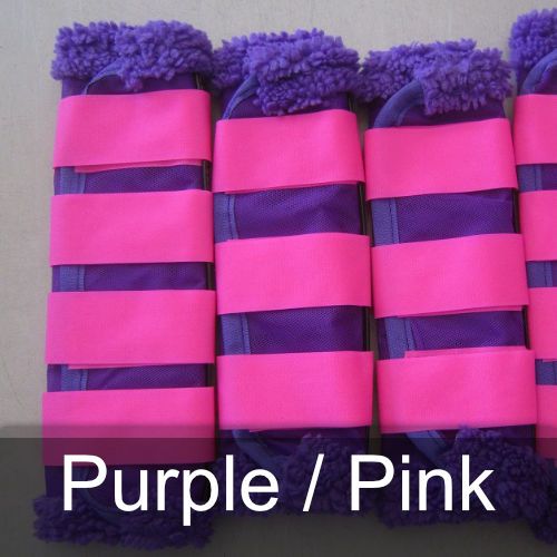 Purple and pink striped boots are lined up on a table