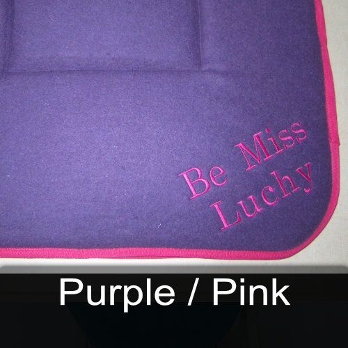 A purple towel with the words be miss lucky embroidered on it
