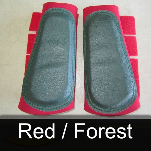 A pair of red / forest boots on a table