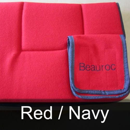 A red blanket with the name beauroc embroidered on it