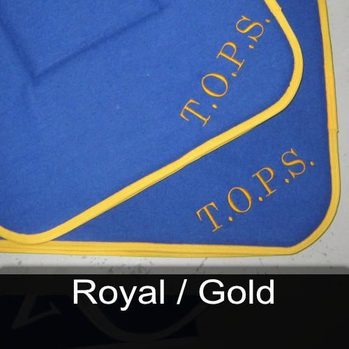 A blue cushion with the words t.o.p.s. embroidered on it