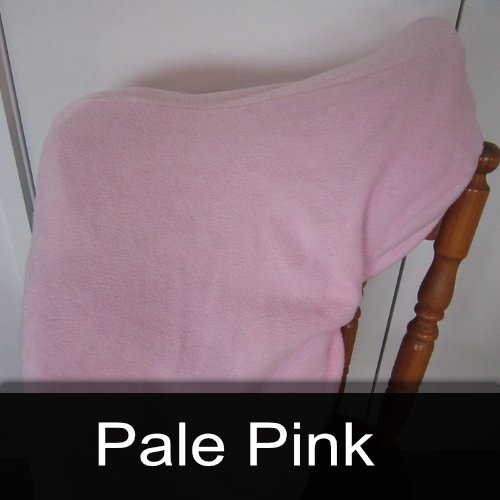 A pale pink blanket is sitting on a chair