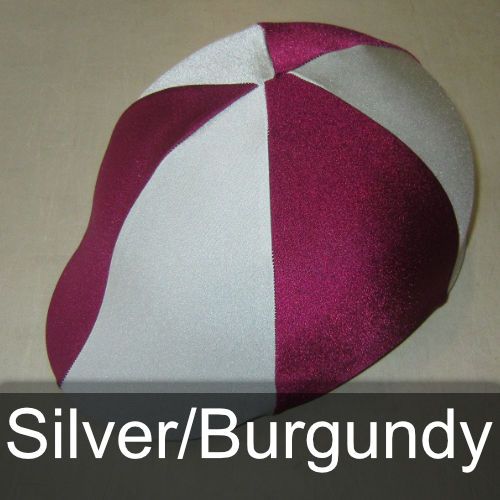 A silver and burgundy hat is sitting on a table
