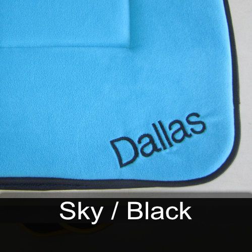 A blue blanket with dallas embroidered on it