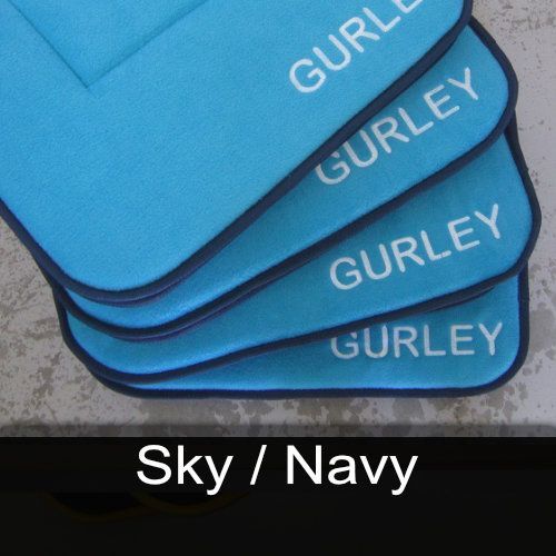 Four blue cushions with gurley written on them are stacked on top of each other