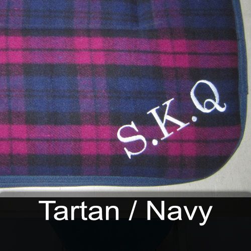 A plaid blanket with the name s.k.q embroidered on it