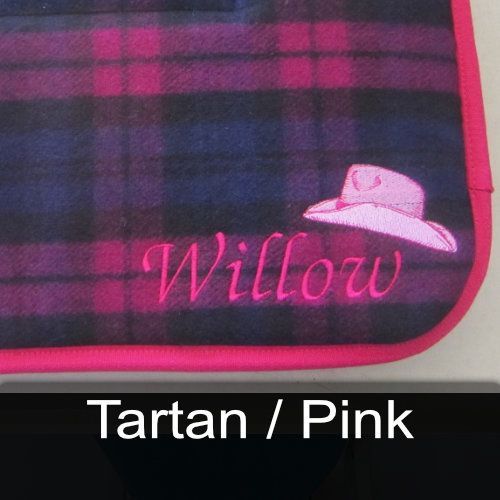 A plaid blanket with the name willow embroidered on it