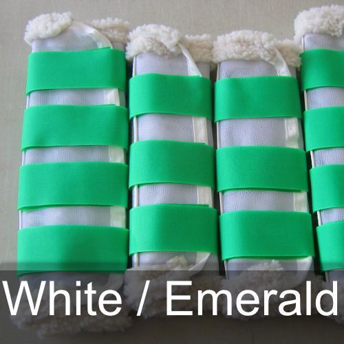 A row of white and green boots with the words white / emerald below them