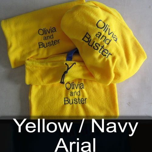 A yellow towel with olivia and buster embroidered on it